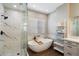 Modern bathroom featuring a walk-in shower, soaking tub and stylish fixtures for a luxurious experience at 4805 E Monte Cristo Ave, Scottsdale, AZ 85254
