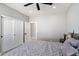Bedroom featuring a large bed, ceiling fan, a door to another room and a closet at 4805 E Monte Cristo Ave, Scottsdale, AZ 85254