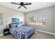Bright bedroom featuring a ceiling fan, neutral walls, and a large window for natural light at 4805 E Monte Cristo Ave, Scottsdale, AZ 85254