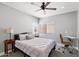 Comfortable bedroom with a ceiling fan, large window, side table, and a dedicated study area at 4805 E Monte Cristo Ave, Scottsdale, AZ 85254