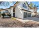 Charming two-story home showcasing a terracotta roof, gray garage doors, and desert landscaping at 4805 E Monte Cristo Ave, Scottsdale, AZ 85254