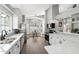 Modern kitchen with stainless steel appliances, quartz countertops, and a cozy breakfast nook at 4805 E Monte Cristo Ave, Scottsdale, AZ 85254