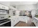 Open concept kitchen showcasing white cabinets, quartz countertops, and seamless transitions to other living spaces at 4805 E Monte Cristo Ave, Scottsdale, AZ 85254