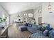 Open concept living space with hardwood flooring, vaulted ceiling, and a custom blue velvet sofa at 4805 E Monte Cristo Ave, Scottsdale, AZ 85254