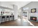 Living area showcasing hardwood floors, a fireplace, and an open floor plan leading to the kitchen at 4805 E Monte Cristo Ave, Scottsdale, AZ 85254