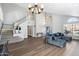 Spacious living area with hardwood floors, a vaulted ceiling, and an elegant staircase at 4805 E Monte Cristo Ave, Scottsdale, AZ 85254