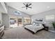 Bright main bedroom featuring a large slider door leading to pool area with a serene atmosphere and natural light at 4805 E Monte Cristo Ave, Scottsdale, AZ 85254