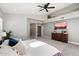 Well-lit bedroom featuring a ceiling fan, dresser, and a view of a mounted television for relaxed viewing at 4805 E Monte Cristo Ave, Scottsdale, AZ 85254