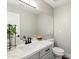 Well-lit powder room featuring a vessel sink, modern fixtures, and a large mirror at 4805 E Monte Cristo Ave, Scottsdale, AZ 85254