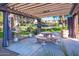 Outdoor barbecue area with stainless steel grills, stone tables, and covered seating at 5345 E Van Buren St # 141, Phoenix, AZ 85008