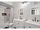 Well-lit bathroom showcasing double sinks, modern fixtures, and a shower with stylish tiling at 5345 E Van Buren St # 141, Phoenix, AZ 85008