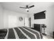 Spacious bedroom with ceiling fan, dresser, and large window with neighborhood views at 5345 E Van Buren St # 141, Phoenix, AZ 85008