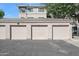 Exterior view of the garage doors and facade, showcasing well-maintained stucco walls at 5345 E Van Buren St # 141, Phoenix, AZ 85008