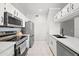 Well-equipped kitchen with stainless steel appliances, white cabinets, and sleek countertops at 5345 E Van Buren St # 141, Phoenix, AZ 85008