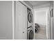 Convenient laundry closet with stacked washer and dryer units, with a bedroom visible in the background at 5345 E Van Buren St # 141, Phoenix, AZ 85008