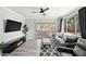 Modern living room with a fireplace, sleek furniture, and access to an outdoor patio at 5345 E Van Buren St # 141, Phoenix, AZ 85008