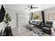 Bright living room featuring a comfortable gray sofa, stylish patterned rug, and sliding glass doors at 5345 E Van Buren St # 141, Phoenix, AZ 85008