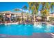 Resort-style pool featuring fountains, palm trees, and comfortable lounge seating at 5345 E Van Buren St # 141, Phoenix, AZ 85008