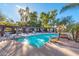 Beautiful pool area with shaded seating, lush landscaping, and clear blue water at 5345 E Van Buren St # 141, Phoenix, AZ 85008