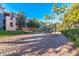 Outdoor volleyball court with well-maintained sand, net, and surrounding landscaping at 5345 E Van Buren St # 141, Phoenix, AZ 85008