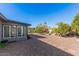 Expansive backyard with desert landscaping, mature trees, and a brick pathway at 6224 E Decatur St, Mesa, AZ 85205