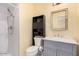 Well-lit bathroom with a modern vanity, toilet, and a shower with white tiled walls at 6224 E Decatur St, Mesa, AZ 85205