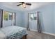 Cozy bedroom featuring soft blue walls, plush carpet, and windows offering natural light at 6224 E Decatur St, Mesa, AZ 85205