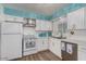 Bright kitchen features white cabinets, stainless steel appliances, subway tile backsplash, and wood-look flooring at 6224 E Decatur St, Mesa, AZ 85205