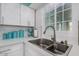 Bright kitchen featuring white cabinetry, stainless steel sink, and modern appliances at 6224 E Decatur St, Mesa, AZ 85205