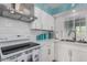 Modern kitchen with white subway tile backsplash, modern appliances, and a stainless steel sink at 6224 E Decatur St, Mesa, AZ 85205