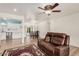 Inviting living room featuring hardwood floors, modern lighting, and a comfortable leather sofa at 6224 E Decatur St, Mesa, AZ 85205