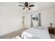 Cozy main bedroom with a ceiling fan, neutral carpeting, and an ensuite bathroom at 6224 E Decatur St, Mesa, AZ 85205