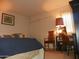 Bedroom with a blue comforter, a lamp, and a desk with chairs and a decorative picture at 7348 N Via Camello Del Norte -- # 223, Scottsdale, AZ 85258