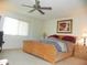 Bright bedroom featuring a ceiling fan, painting, carpeted floors, and a wooden bed frame at 7348 N Via Camello Del Norte -- # 223, Scottsdale, AZ 85258