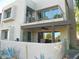 Exterior view of a two-story home with stucco walls, a balcony, and a covered patio at 7348 N Via Camello Del Norte -- # 223, Scottsdale, AZ 85258