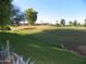 Beautiful golf course view with well-manicured green, mature trees, and blue sky at 7348 N Via Camello Del Norte -- # 223, Scottsdale, AZ 85258