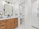 Bathroom featuring wood vanity and white horizontal shiplap wall with updated lighting at 7525 E Latham St, Scottsdale, AZ 85257