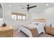 Bright bedroom with a ceiling fan, modern window treatment, and a comfortable queen bed at 7525 E Latham St, Scottsdale, AZ 85257