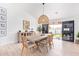 Bright dining room features neutral wood tones, contemporary decor, and sliding glass doors to the backyard at 7525 E Latham St, Scottsdale, AZ 85257