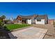 Wide shot of backyard featuring an outdoor seating area, lush lawn, and partial concrete space at 7525 E Latham St, Scottsdale, AZ 85257