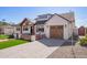 Inviting home featuring a paved driveway, attached two-car garage, and manicured front yard at 7525 E Latham St, Scottsdale, AZ 85257