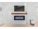 Modern fireplace featuring a sleek design, wooden mantle, and built-in television at 7525 E Latham St, Scottsdale, AZ 85257