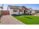 Charming single-Gathering home with a lush, green lawn, gravel driveway, and stylish exterior at 7525 E Latham St, Scottsdale, AZ 85257