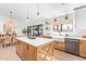 Bright kitchen features custom cabinetry, stainless steel appliances, a farmhouse sink, and dining area at 7525 E Latham St, Scottsdale, AZ 85257