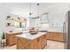 Bright kitchen features custom cabinetry, stainless steel appliances, a farmhouse sink, and brick accents at 7525 E Latham St, Scottsdale, AZ 85257