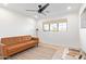 Relaxing living room with a sleek ceiling fan and a window providing natural light at 7525 E Latham St, Scottsdale, AZ 85257