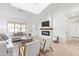 Bright living room featuring hardwood floors, neutral furniture, and cozy fireplace at 7525 E Latham St, Scottsdale, AZ 85257