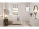 Bright bedroom with large windows, light-colored walls, and a stylish dresser at 7993 W Griswold Rd, Peoria, AZ 85345