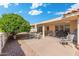Well maintained backyard featuring a large concrete patio with an outdoor dining area and mature landscaping at 8303 E Monterey Ave, Mesa, AZ 85209