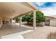Covered patio provides shade overlooking a low-maintenance backyard featuring mature landscaping at 8303 E Monterey Ave, Mesa, AZ 85209
